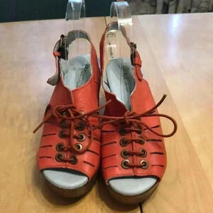 Eric Michael orange lace-up sandal with wooden heel.
